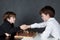 Two serious boy playing chess, studio