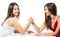 Two serious competetive women having arm wrestling fight, compete with each other.