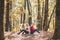 Two serious girls having smartphone conversation. Teenage girl using mobile phone in autumn park.