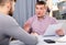 Two serious men analysing documents at table