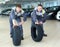 Two servicemen repairmen automobile mechanic with two tires