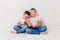 Two seven-year-old boys keep only born girl on white background