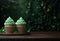 two shamrock frosting cupcakes sitting on a wooden table