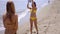 Two shapely women playing with a beach ball