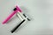 Two shaving sticks and white tube with shaving cream on light background with shadows. Pink for women and black for man. Family