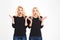 Two shocked surprised blonde amusing sisters twins