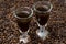 Two shot glasses of coffee liqueur, selective focus