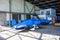 Two shrouded small sports aircraft in a hangar