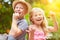 Two siblings eat cherries in summer