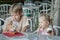 Two siblings eating dessert in Italian ice cream bar gelateria