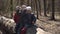 Two siblings have fun in the forest sitting on a tree, slow-mo