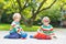 Two siblings, kid boys playing with red school bus