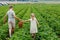 Two siblings, preschool girl and school boy having fun with picking on strawberry farm in summer. Children, sister and