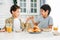 Two siblings tween boys real brothers having breakfast on bright kitchen at home