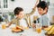 Two siblings tween boys real brothers having breakfast on bright kitchen at home