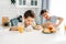 Two siblings tween boys real brothers having breakfast on bright kitchen at home. Child doesn`t want to eat