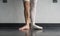 Two sides to a ballerina, one leg wearing her ballet slipper pointe shoe on one foot, and one leg bare