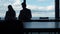 Two silhouettes working sea view in office. Business partners checking documents