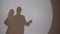 Two silhouettes of young people. Reflection of a dancing pair of shadows on the wall. Dancing shadows on the wall guy