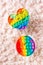 Two silicone rainbow anti-stress toys on the background of fluff. A modern way to relax. Vertical view