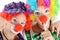 Two silly women as clowns made up in costume for carnival point at their red noses
