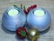 Two silver ball shaped candles table decoration on oak tree wood background.