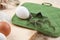 Two silver cookie mold with white egg on wooden table