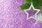 Two silver star on a Christmas tree branch on a purple shining background from bokeh, mock up