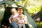 Two sister with dad at campground in mountains.