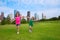 Two sister girls friends running holding hand in urban skyline