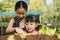 Two sister planting seedling in farm