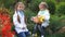 Two sisters in an autumn park