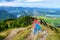 Two sisters enjoying picturesque views from the Tegelberg mountain, a part of Ammergau Alps, located nead Fussen town, Germany.