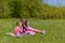 Two sisters had a picnic in a green meadow