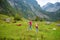 Two sisters on a hiking trails around picturesque Konigssee, known as Germany`s deepest and cleanest lake, located in the extreme