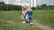 Two sisters holding hands circling on the lawn in the city park outdoors. Freedom and carefree concept