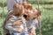 Two sisters kiss their mother on a walk