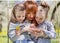 Two sisters kiss their mother on a walk