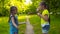 Two sisters little girls blowing soap bubbles in park