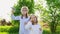 Two sisters little girls inflate soap bubbles on a picnic