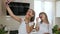 Two sisters with long hair dressed in white clothes show a mustache from red chili pepper doing and makes selfie photo