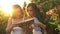 Two sisters outdoors with books