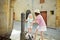 Two sisters playing with drinking water fountain in Montalcino town, located on top of a hill top and surrounded by vineyards,