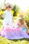 Two sisters playing tea party outdoors