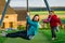 Two sisters: preschooler and teenage - playing on playground