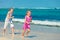 Two sisters running on the beach