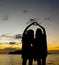 Two sisters silhouette making heart symbol