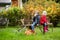 Two sisters sitting on a wooden bench on autumn