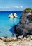 The Two Sisters stacks in front of the shore of Torre dell`Orso