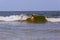 Two sisters swim in the ocean on waves